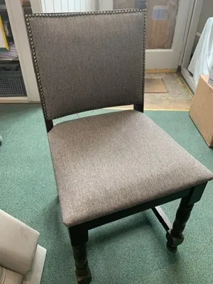 Button-making in progress on a chair