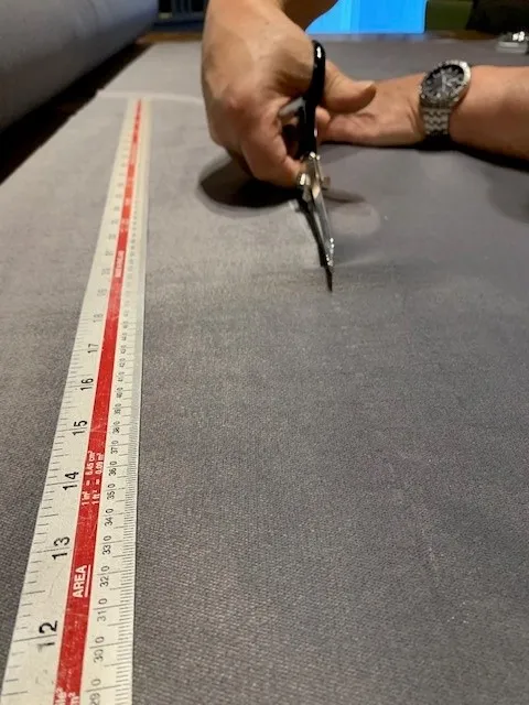 Cutting fabric on the workshop bench