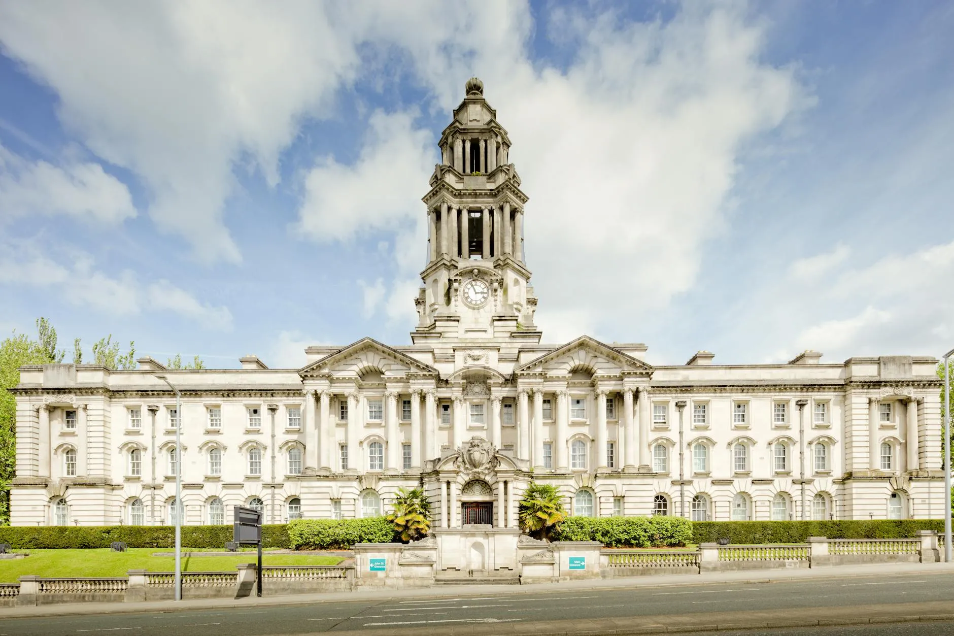 Front view of the iconic Stockport Town Hall with a clear blue sky backdrop. — covered by Valley Upholstery's Stalybridge route