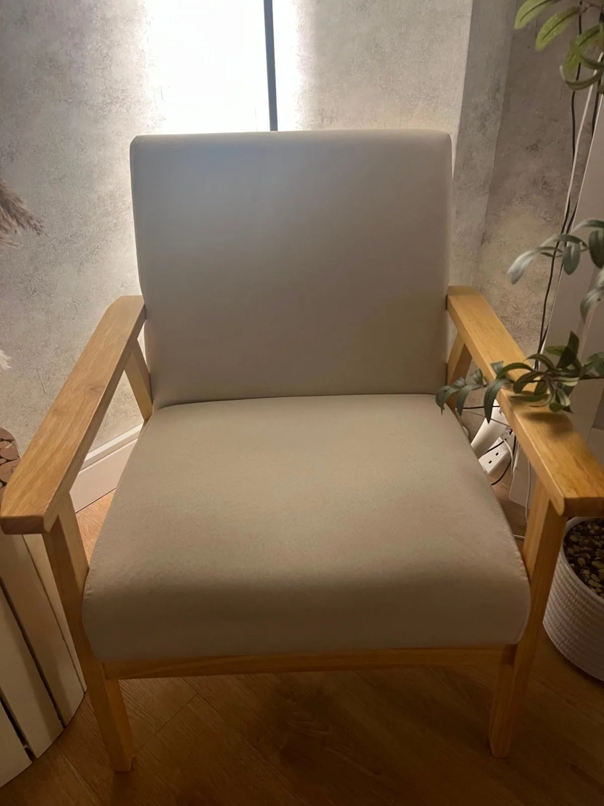 Clinic armchair with cream seat and back on light oak arms, before recovering
