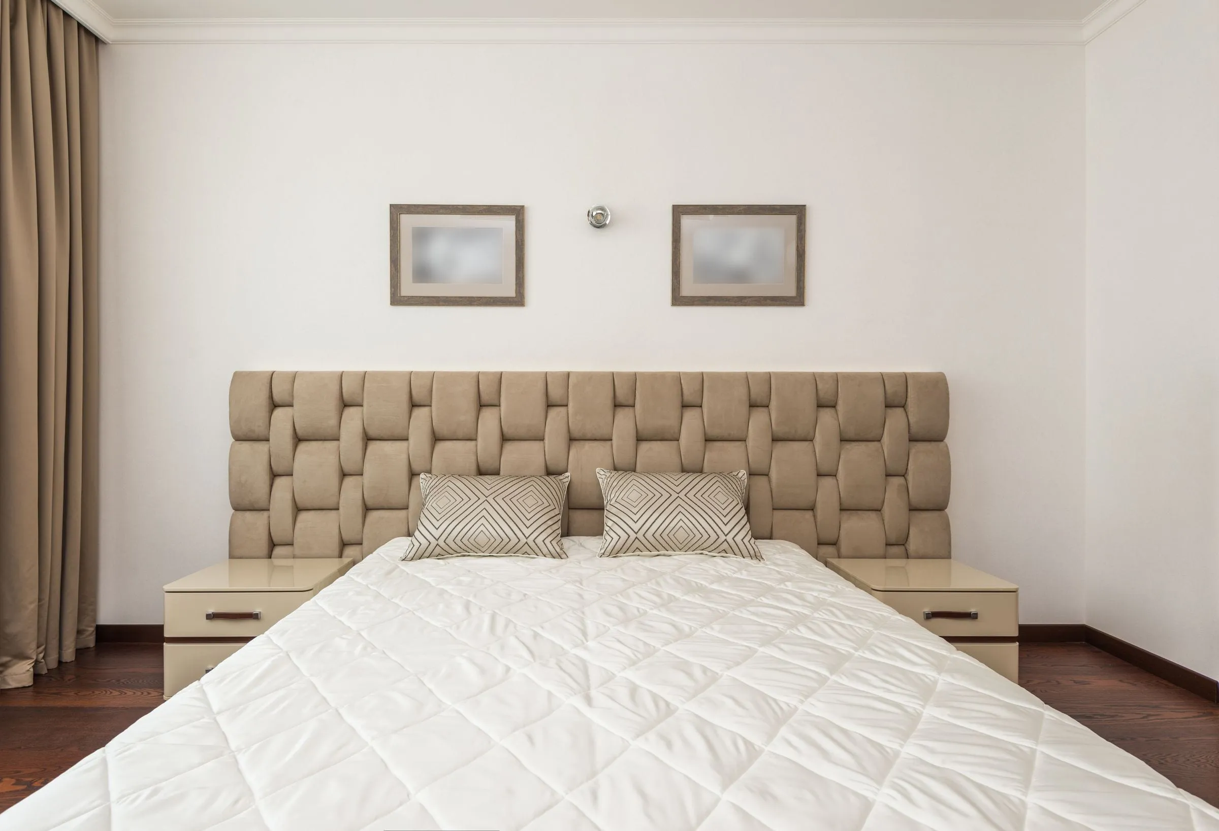 Representative full-width padded headboard wall in a woven panel pattern behind a bed